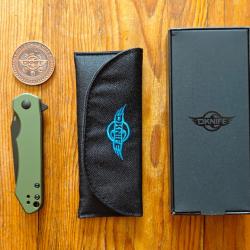 OLIGHT Oknife Freeze, lame Wharncliffe noire en acier 154cm et plaquettes en aluminium OD Green.